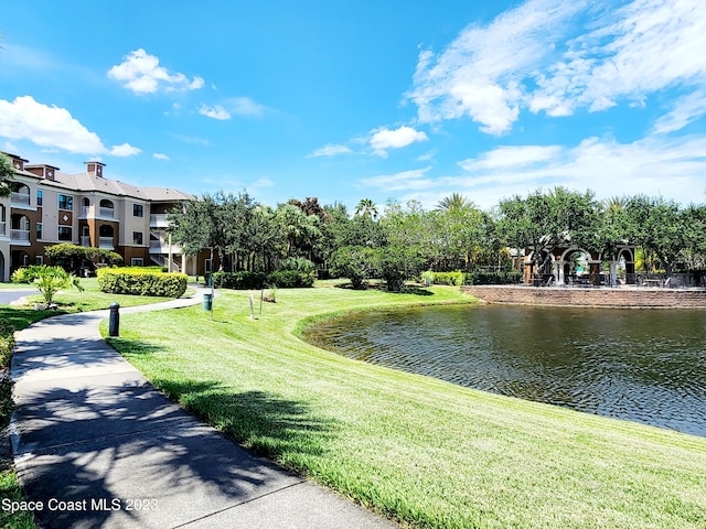 exterior space featuring a yard and a water view