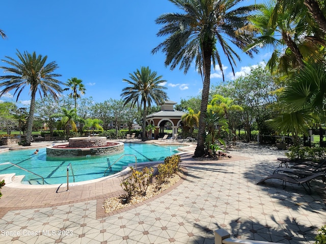 view of pool featuring a gazebo, a jacuzzi, and a patio area