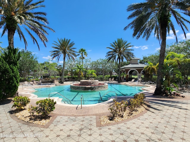 view of swimming pool featuring a gazebo, a hot tub, and a patio area