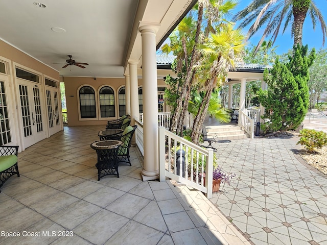 view of terrace with ceiling fan and french doors