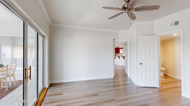 spare room featuring crown molding, ceiling fan, and light wood-type flooring