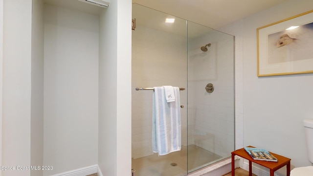 bathroom with toilet and walk in shower