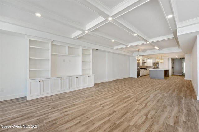 unfurnished living room with beam ceiling, coffered ceiling, a chandelier, and light hardwood / wood-style flooring