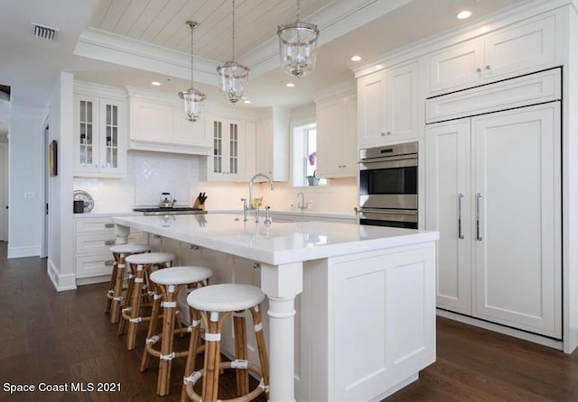 kitchen featuring dark hardwood / wood-style floors, a kitchen island, and white cabinets