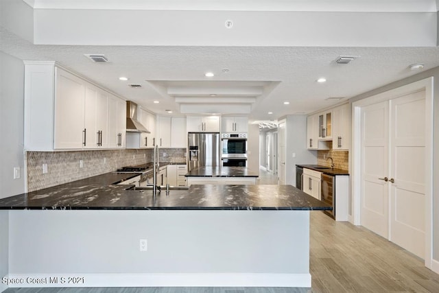 kitchen with backsplash, white cabinets, appliances with stainless steel finishes, and wine cooler