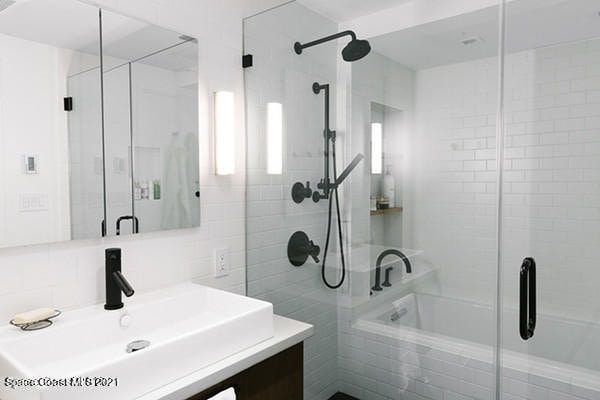 bathroom with vanity and tasteful backsplash