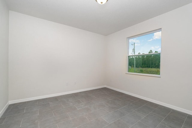 empty room featuring dark tile flooring