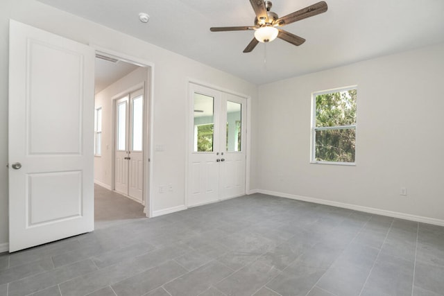 empty room with ceiling fan and tile flooring