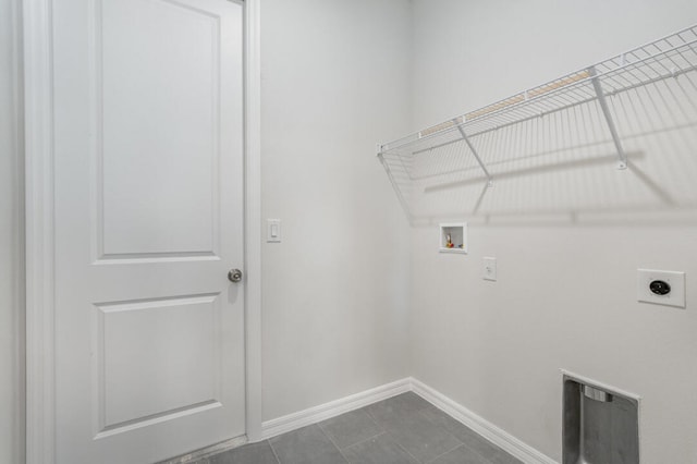 laundry room featuring hookup for an electric dryer, hookup for a washing machine, and dark tile floors