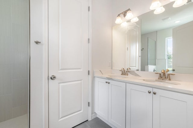 bathroom featuring dual bowl vanity and tile flooring