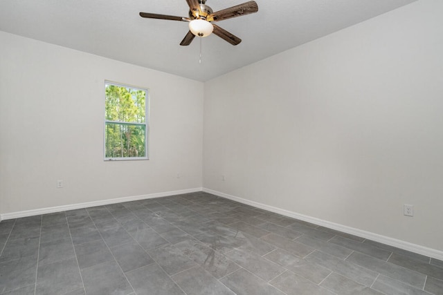 tiled spare room with ceiling fan