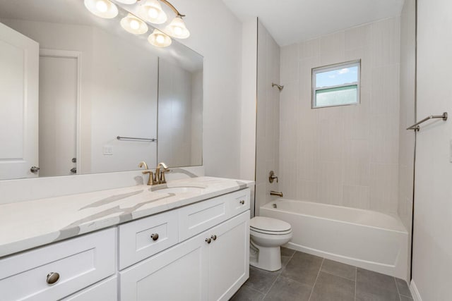 full bathroom with tile flooring, tiled shower / bath, vanity, and toilet