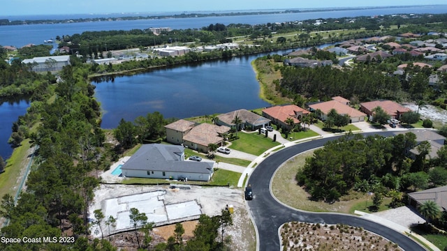 birds eye view of property with a water view