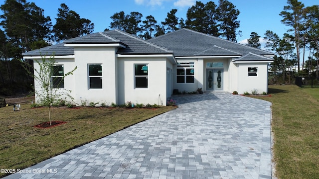 view of front of house featuring french doors and a front yard