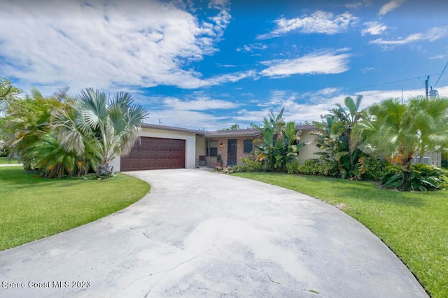 single story home with a front yard and a garage