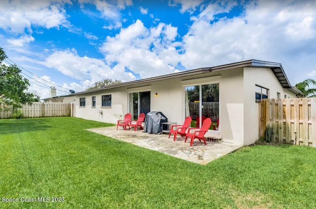 back of house featuring a yard and a patio area