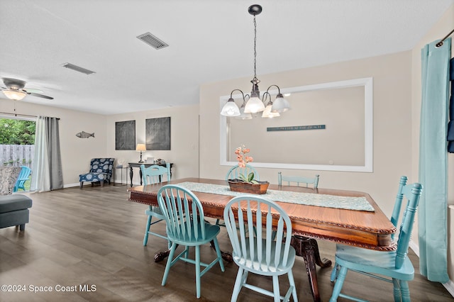 dining area featuring dark hardwood / wood-style floors and ceiling fan with notable chandelier