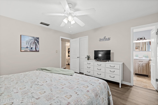 bedroom with ceiling fan, hardwood / wood-style flooring, and ensuite bathroom