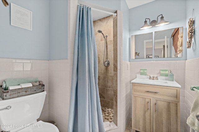 bathroom with vanity, toilet, tile walls, and curtained shower