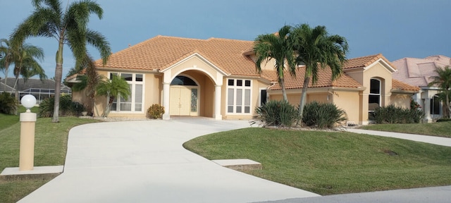 mediterranean / spanish-style house with a front yard