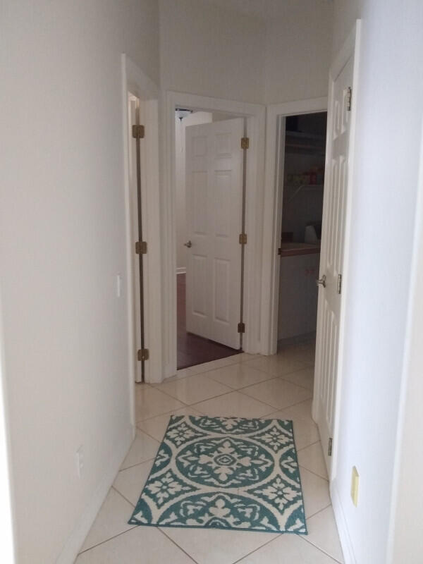 hall with light tile patterned flooring