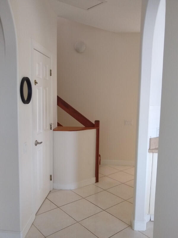 corridor featuring light tile patterned floors