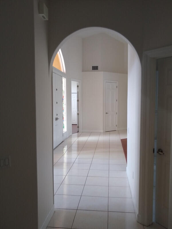 hallway featuring a healthy amount of sunlight and light tile patterned floors