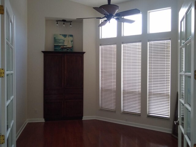 interior space featuring ceiling fan, track lighting, and hardwood / wood-style floors