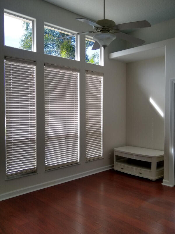 unfurnished room with hardwood / wood-style flooring and ceiling fan