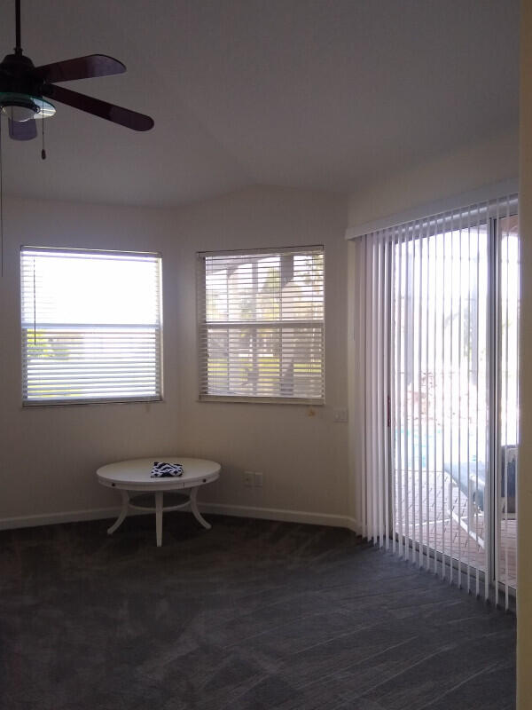 spare room with carpet floors and ceiling fan