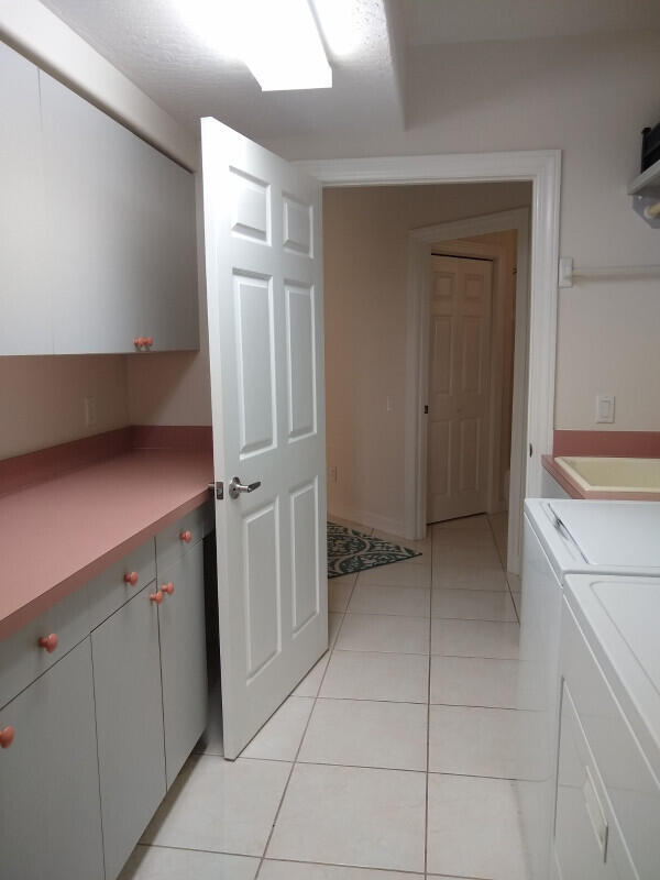 kitchen with washer and clothes dryer and light tile patterned floors