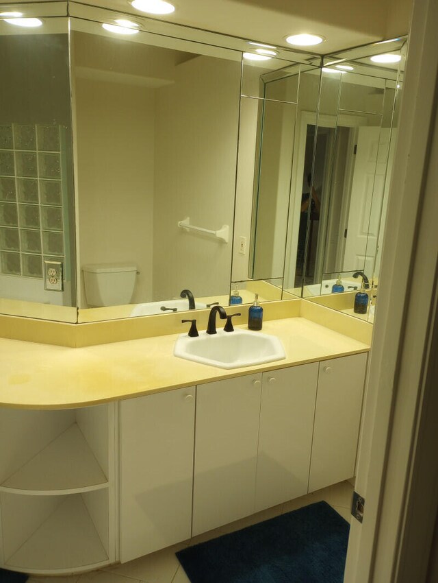 bathroom with tile patterned floors, vanity, and toilet