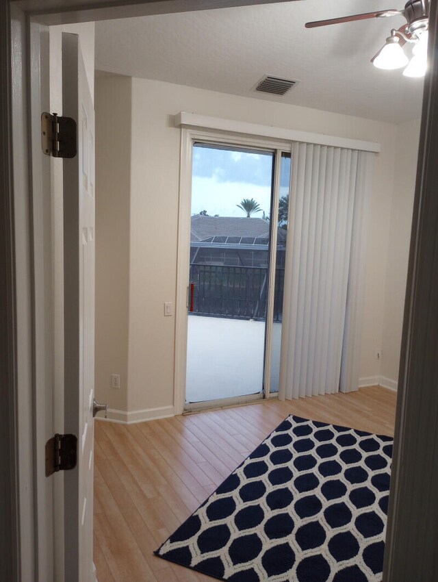 empty room with light hardwood / wood-style floors and ceiling fan