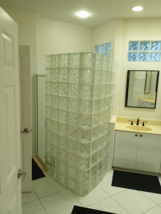 bathroom featuring tile patterned floors, vanity, and a shower