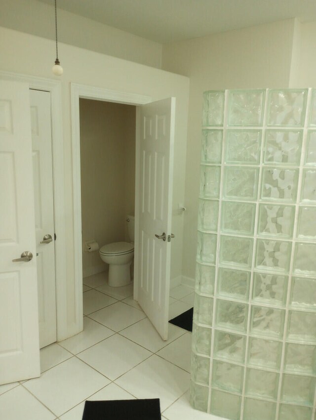 bathroom featuring toilet and tile patterned flooring