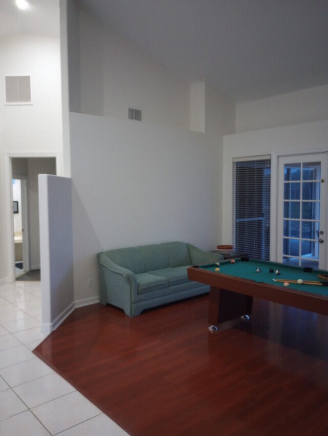 game room featuring billiards, light tile patterned floors, and high vaulted ceiling