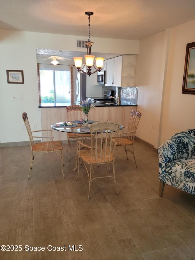 403 Hayes Ave, Cocoa Beach, FL 32931 - dining space with a chandelier and baseboards