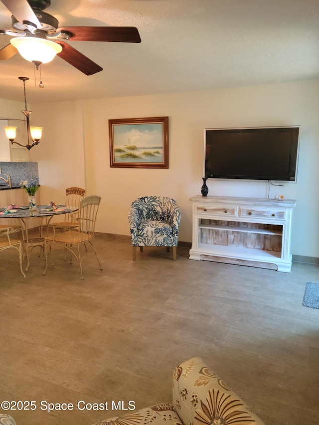 403 Hayes Ave, Cocoa Beach, FL 32931 - living room with a ceiling fan and baseboards
