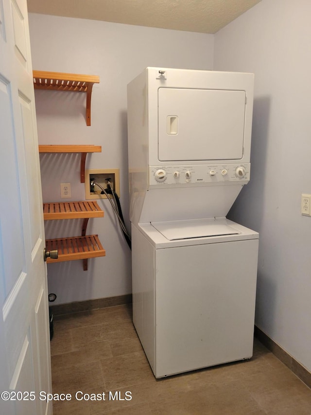 403 Hayes Ave, Cocoa Beach, FL 32931 - laundry room with stacked washer / dryer and baseboards