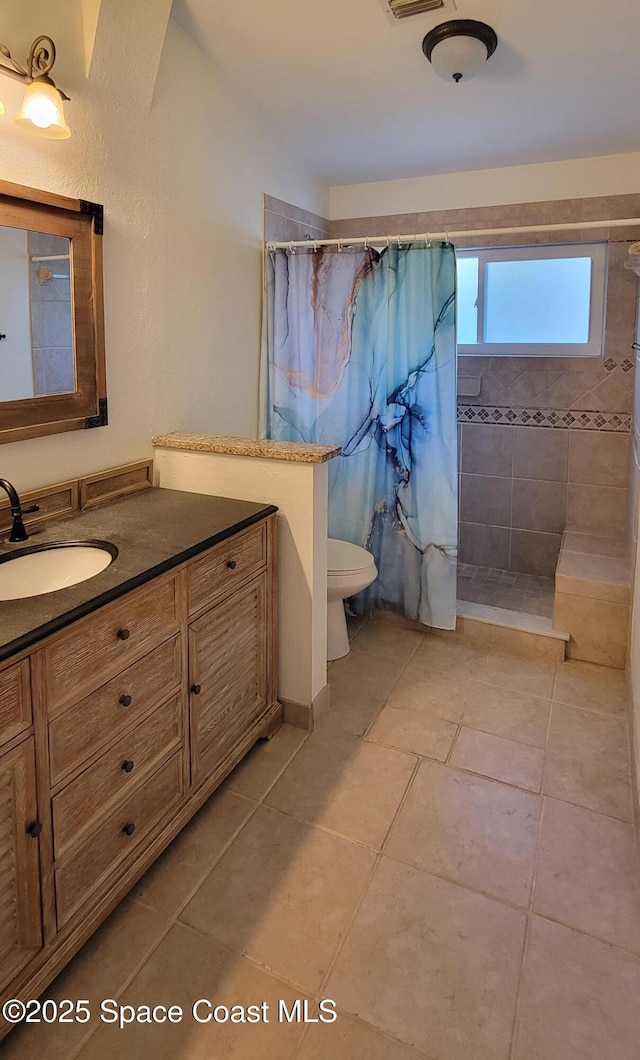 403 Hayes Ave, Cocoa Beach, FL 32931 - bathroom featuring vanity, tiled shower, and tile patterned floors