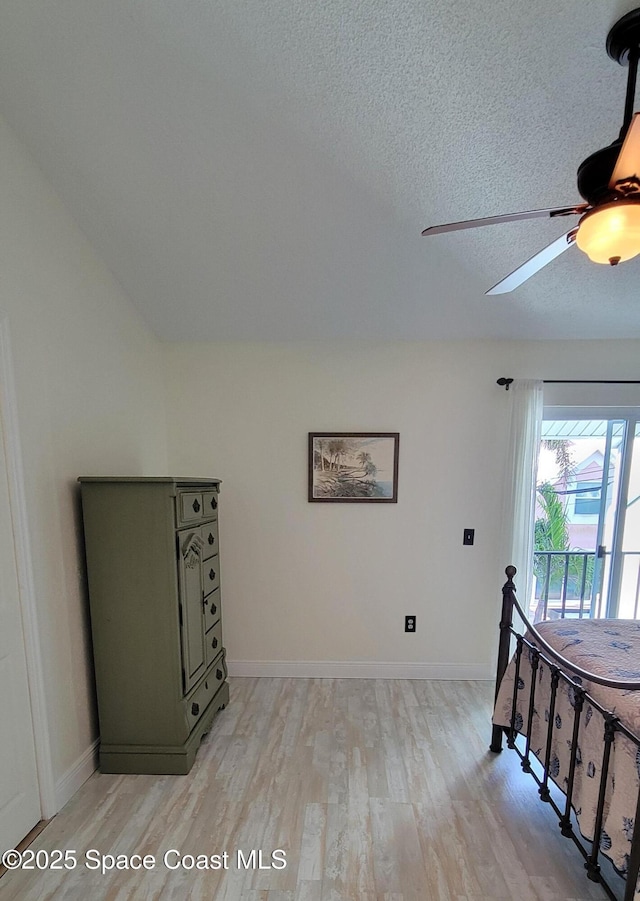403 Hayes Ave, Cocoa Beach, FL 32931 - bedroom featuring light wood-style floors, a textured ceiling, and a ceiling fan