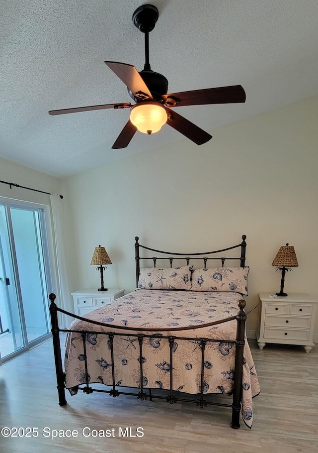403 Hayes Ave, Cocoa Beach, FL 32931 - bedroom with wood finished floors, a textured ceiling, and ceiling fan