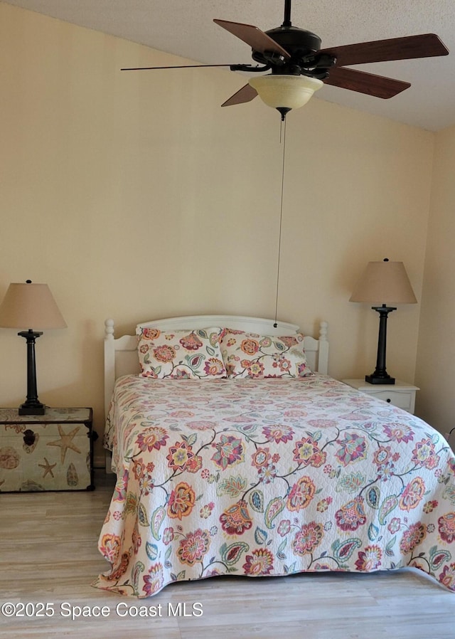 403 Hayes Ave, Cocoa Beach, FL 32931 - bedroom featuring wood finished floors, a ceiling fan, and vaulted ceiling