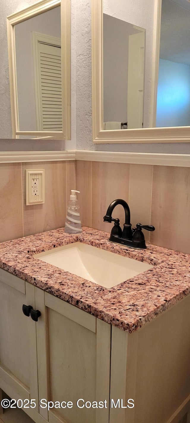 403 Hayes Ave, Cocoa Beach, FL 32931 - bathroom featuring vanity and wainscoting