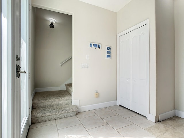 stairway with tile patterned flooring