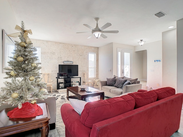 living room with hardwood / wood-style flooring and ceiling fan