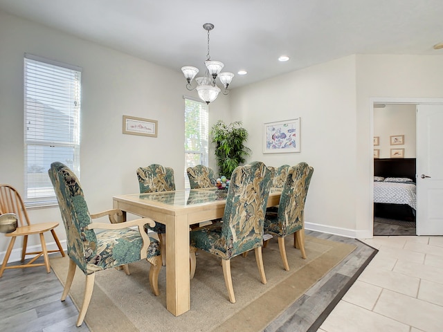 dining room featuring light hardwood / wood-style floors, a notable chandelier, and a wealth of natural light