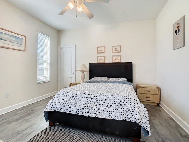 bedroom with dark wood-type flooring and ceiling fan