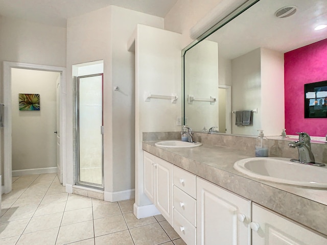 bathroom with vanity, walk in shower, and tile patterned flooring