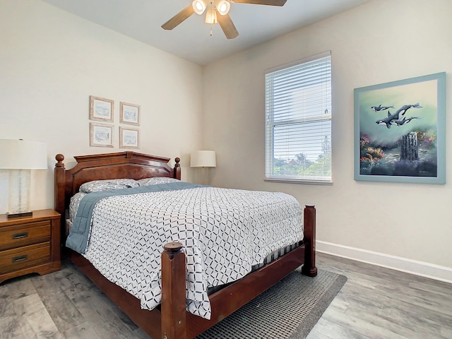 bedroom with ceiling fan and hardwood / wood-style flooring